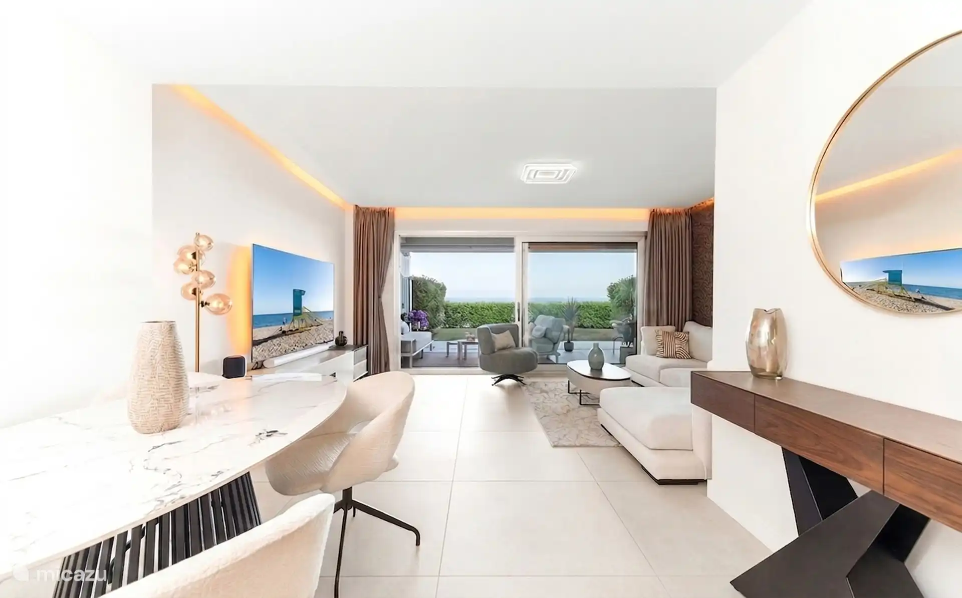 Spacious living room with television and sliding doors to the terrace