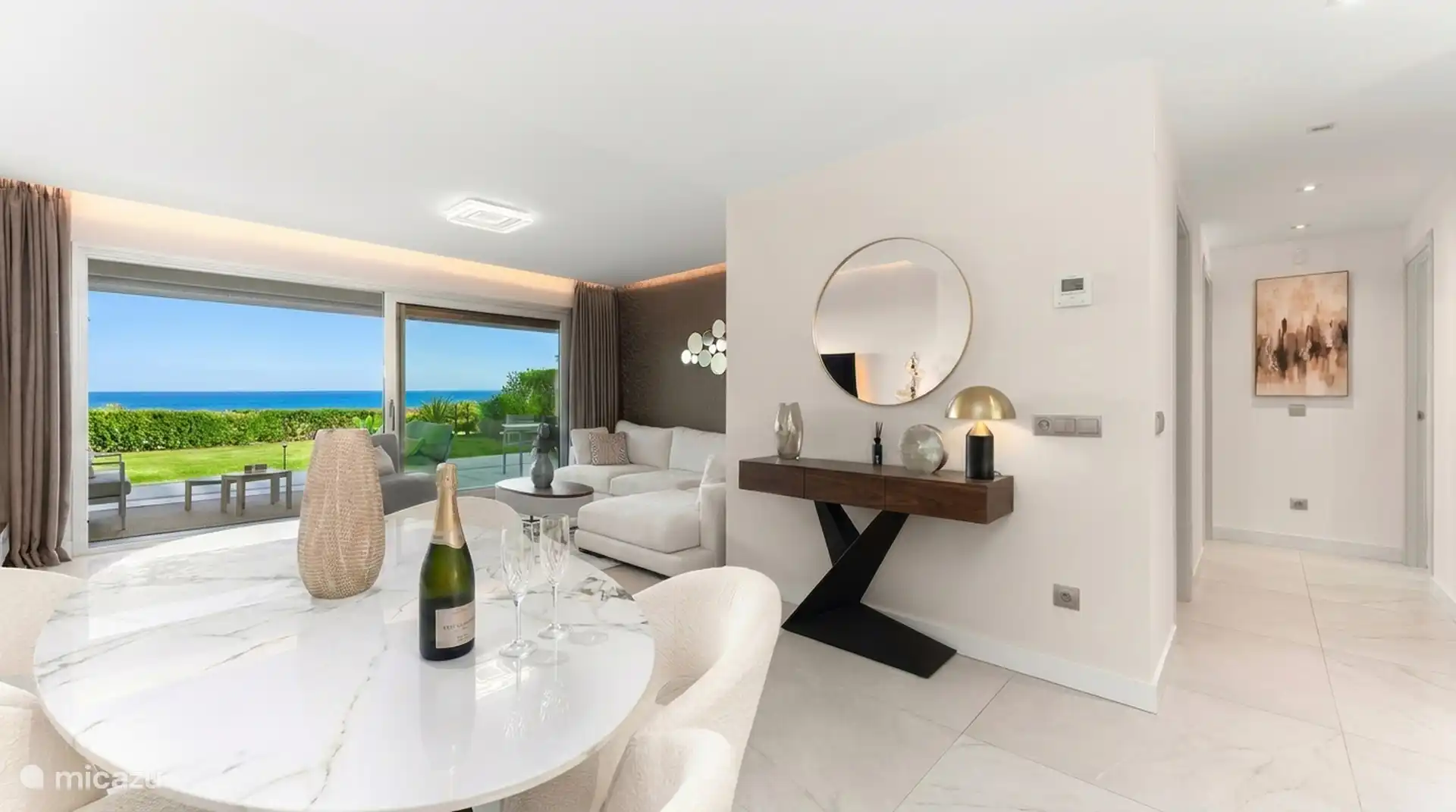 Living room with dining area and view of the terrace and the sea