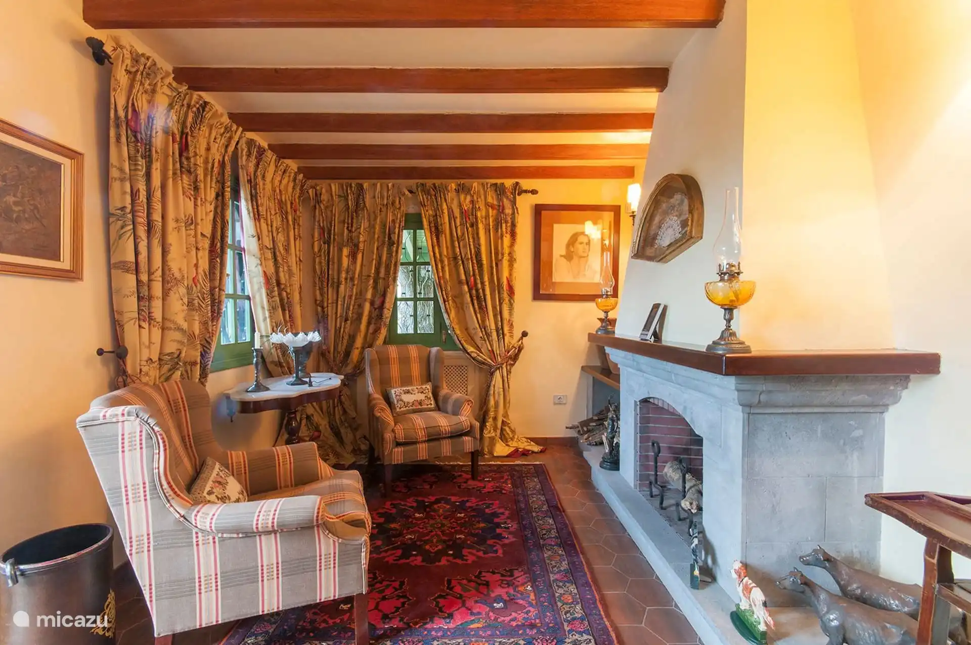Reading nook by the fireplace, with armchairs and curtains