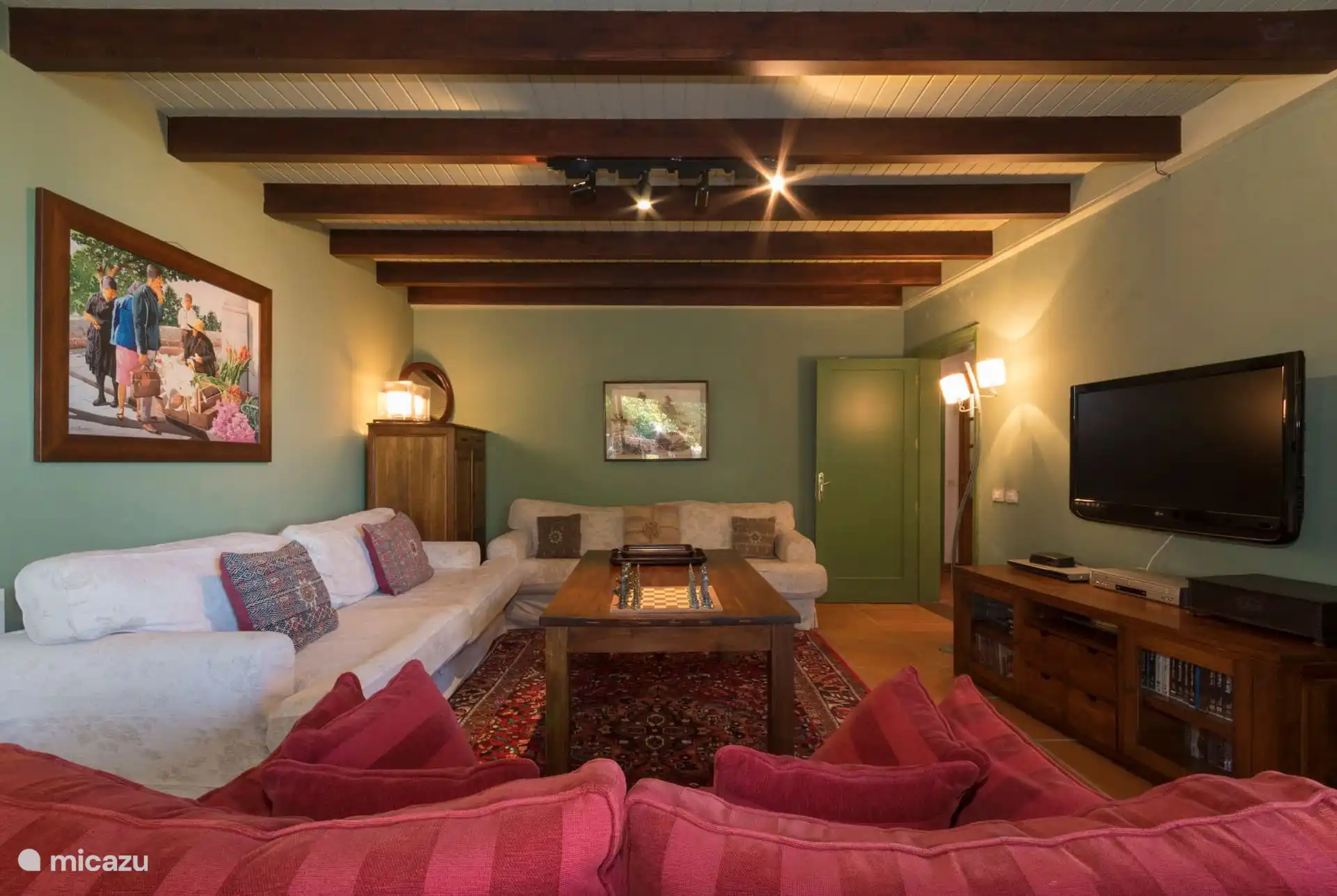 TV lounge with sofas and exposed beamed ceiling