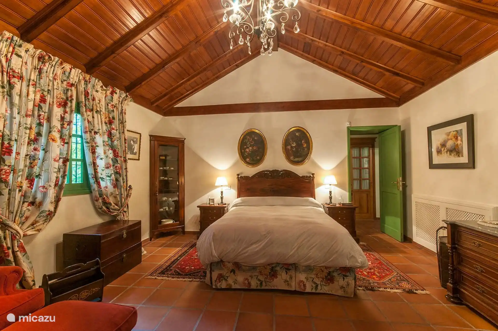 Master bedroom with queen bed and chandelier