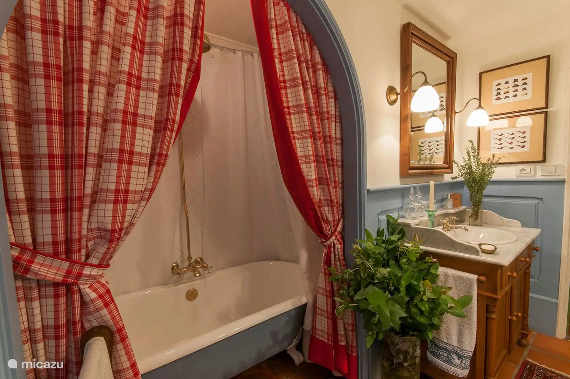 Bathroom with bathtub, checkered curtain and marble sink