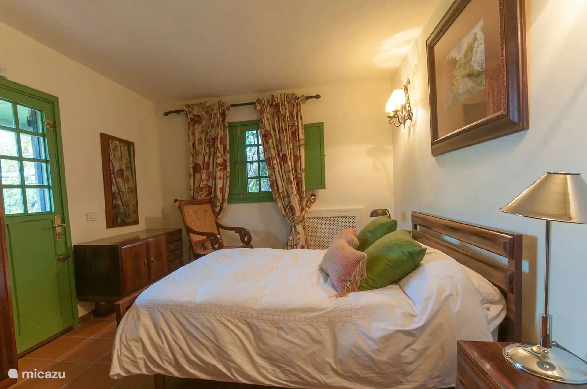 Double bedroom with door to the garden and wooden headboard