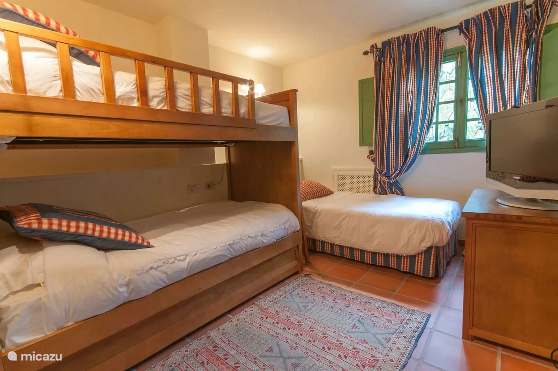 Children's bedroom with bunk bed, single bed and television