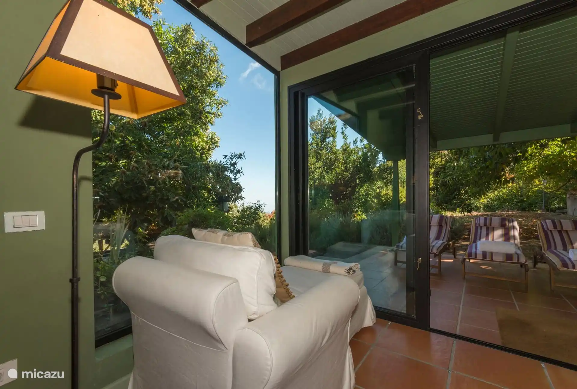 Glazed gallery with garden and terrace views