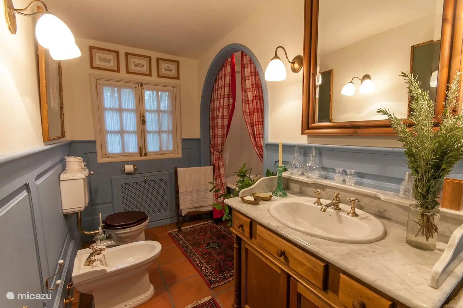 Bathroom with marble sink, bidet and garden window