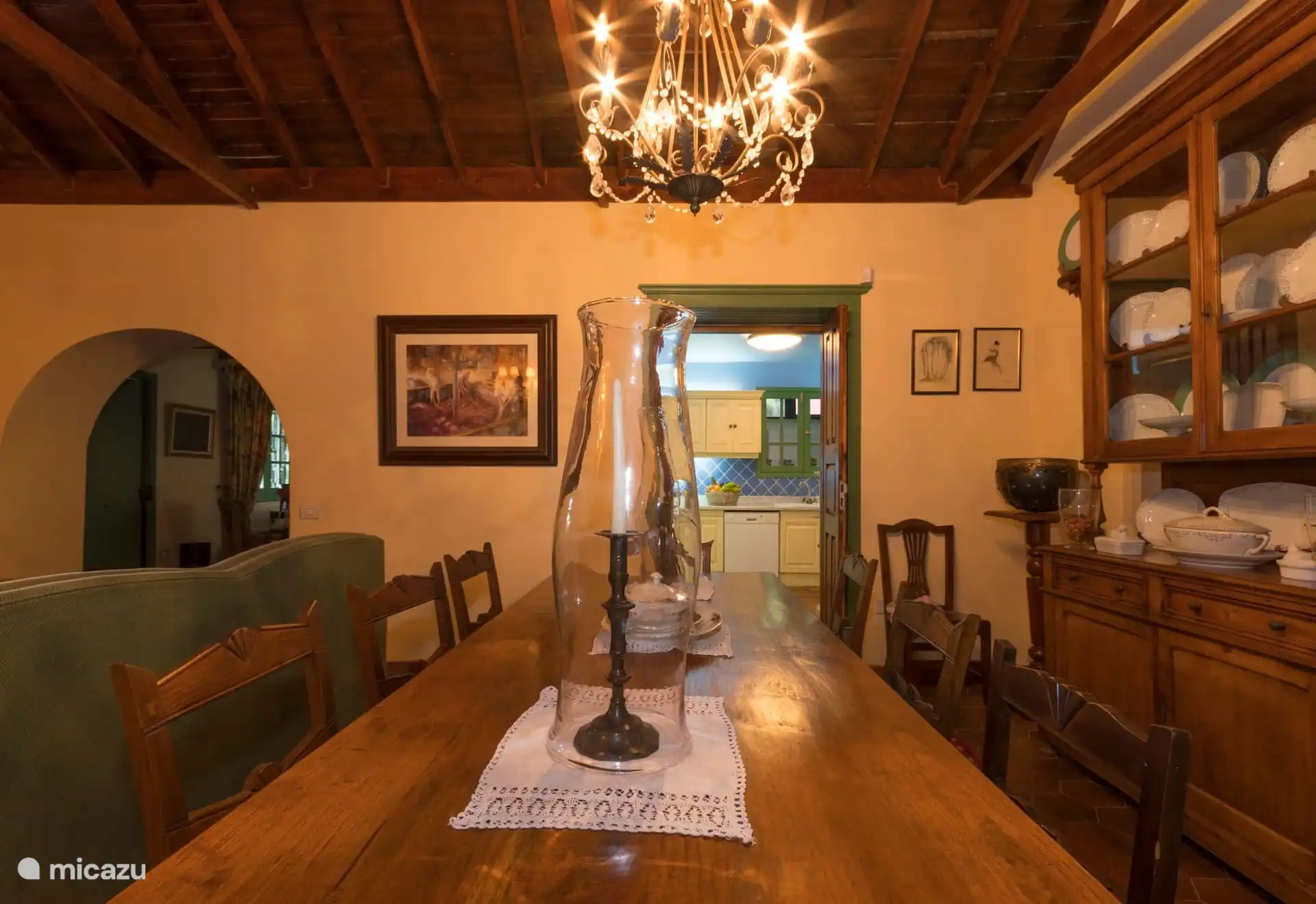 Main dining room with long wooden table and beamed ceiling