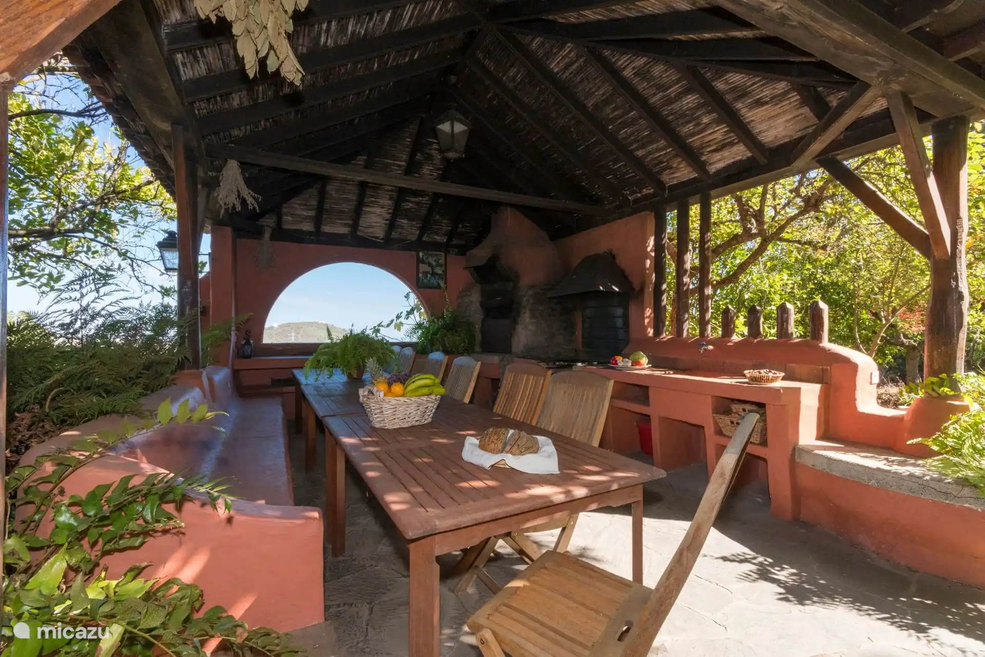Wooden hanger with outdoor dining table and wood oven