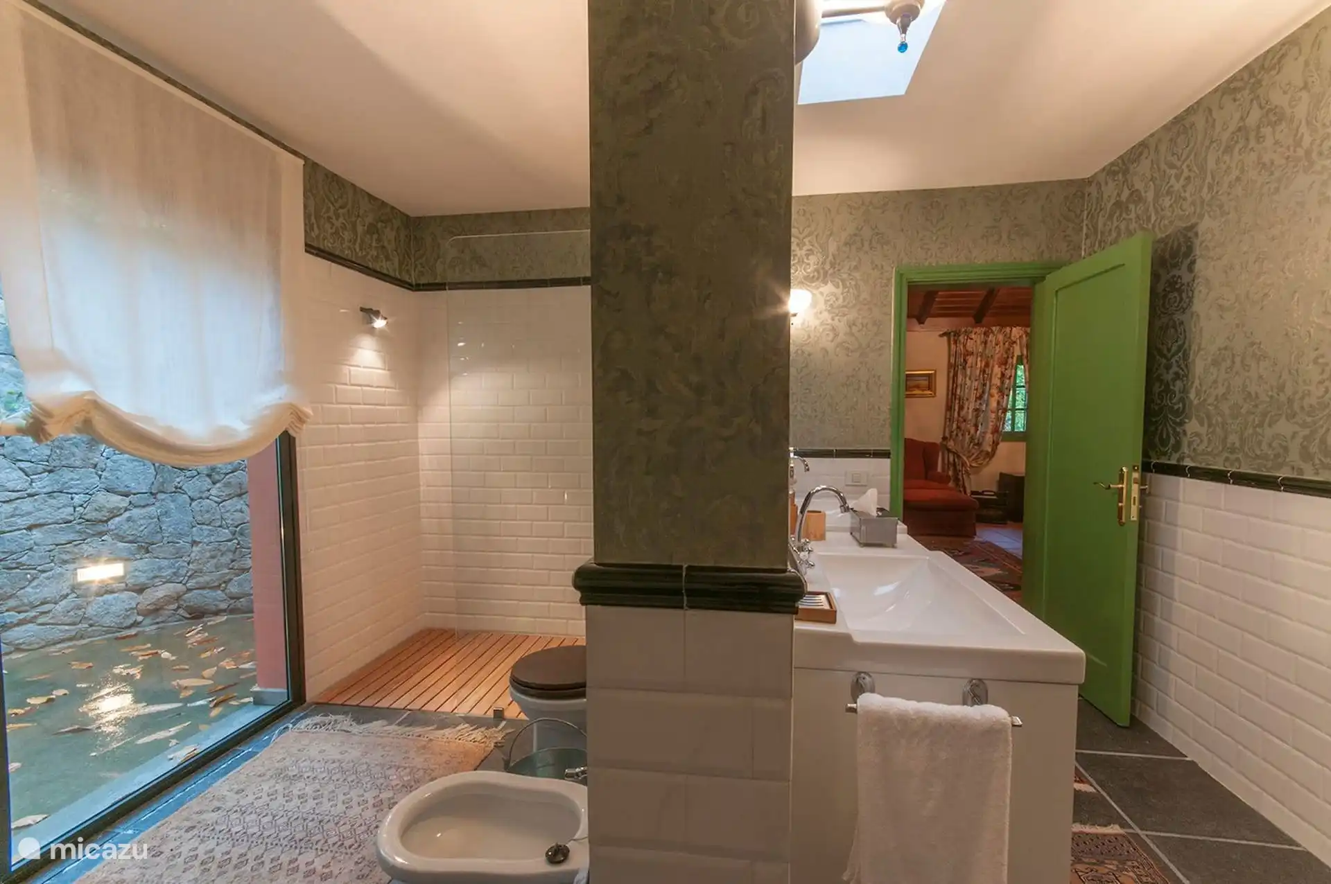 Bathroom with shower, bidet and natural stone wall