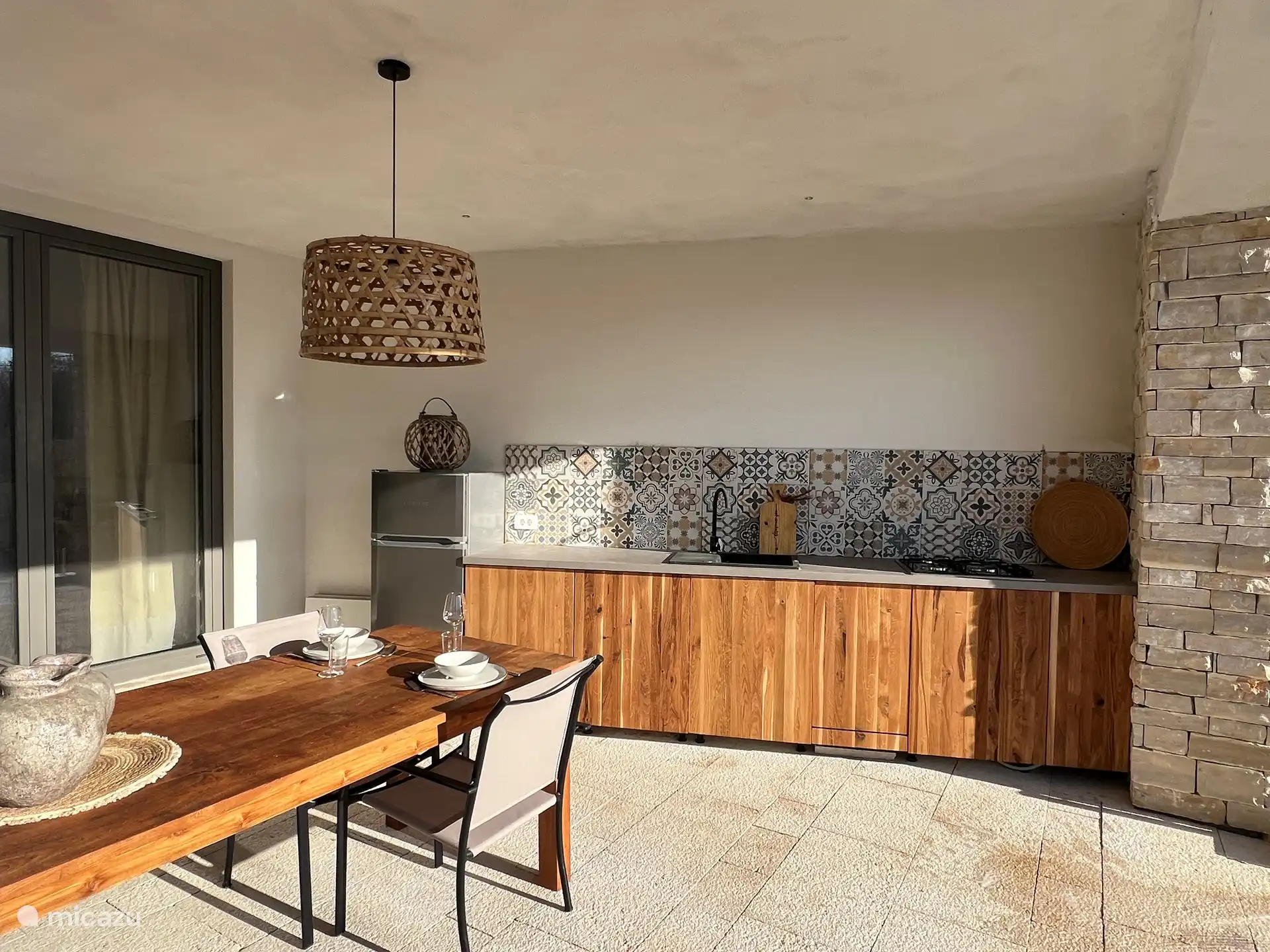 The outdoor kitchen with dining table
