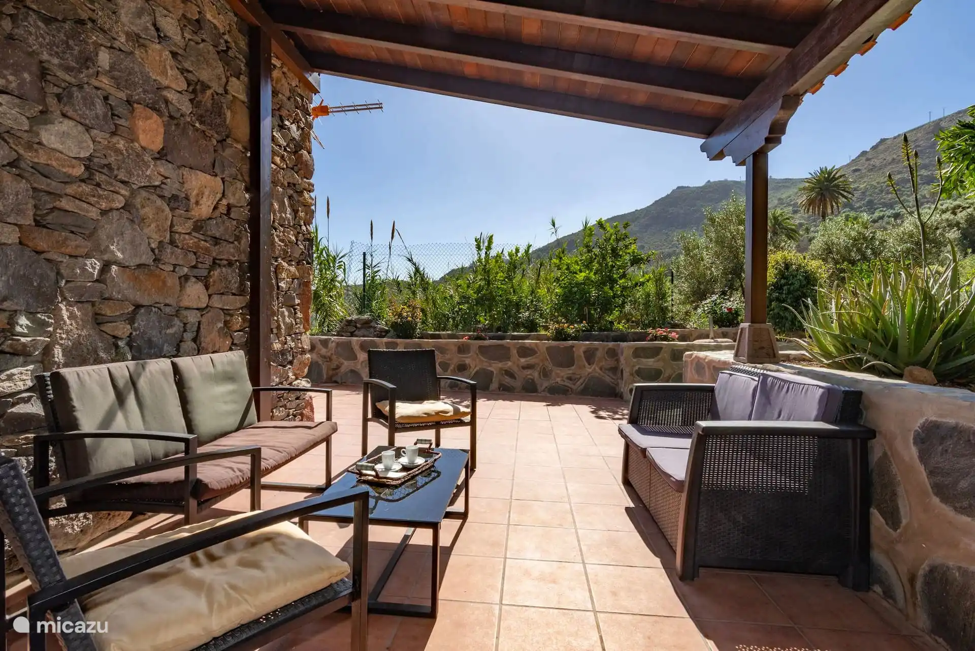 Überdachte Veranda mit Außensofas und Blick auf die Schlucht.