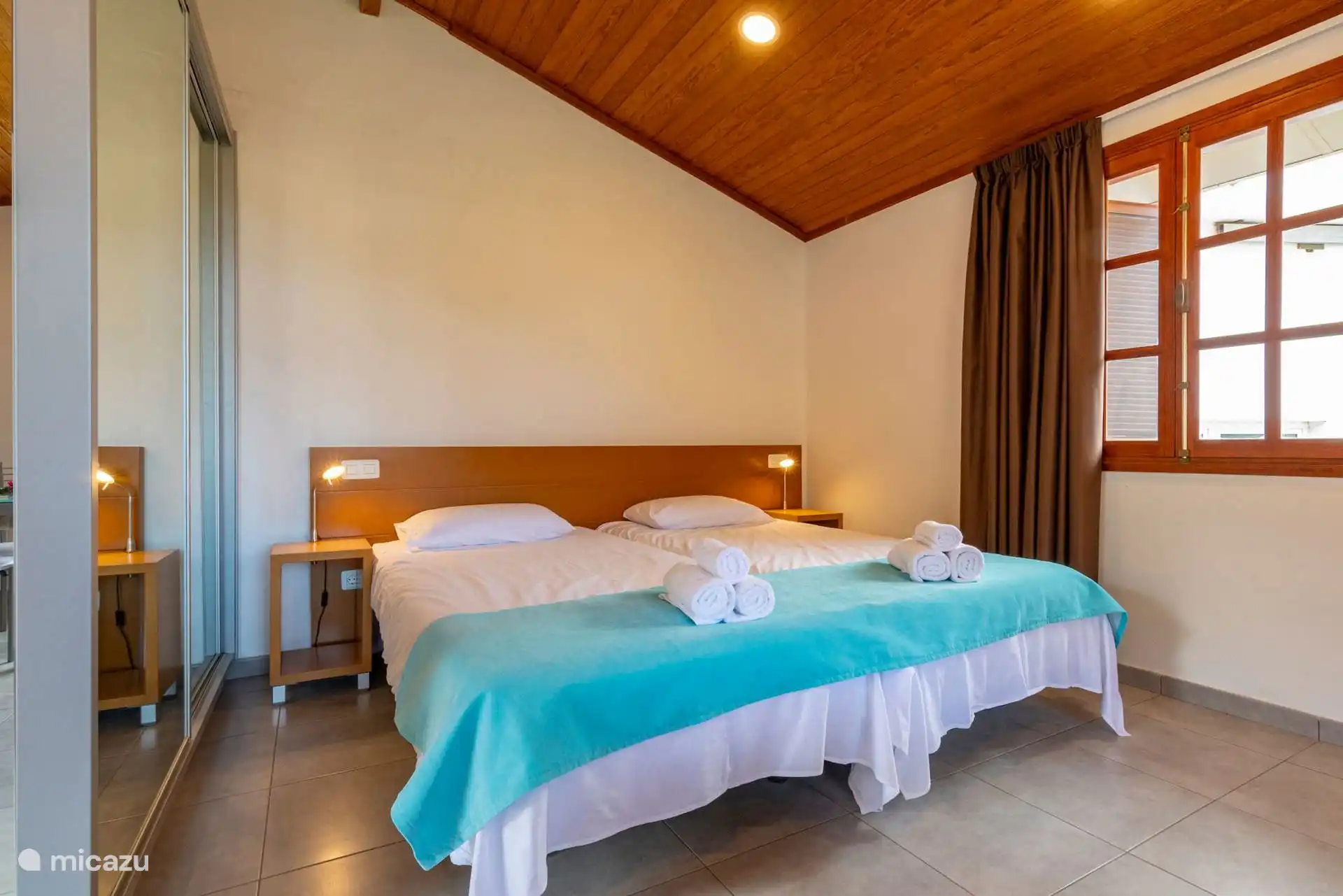 Another view of the bedroom, with the wooden shutter window.
