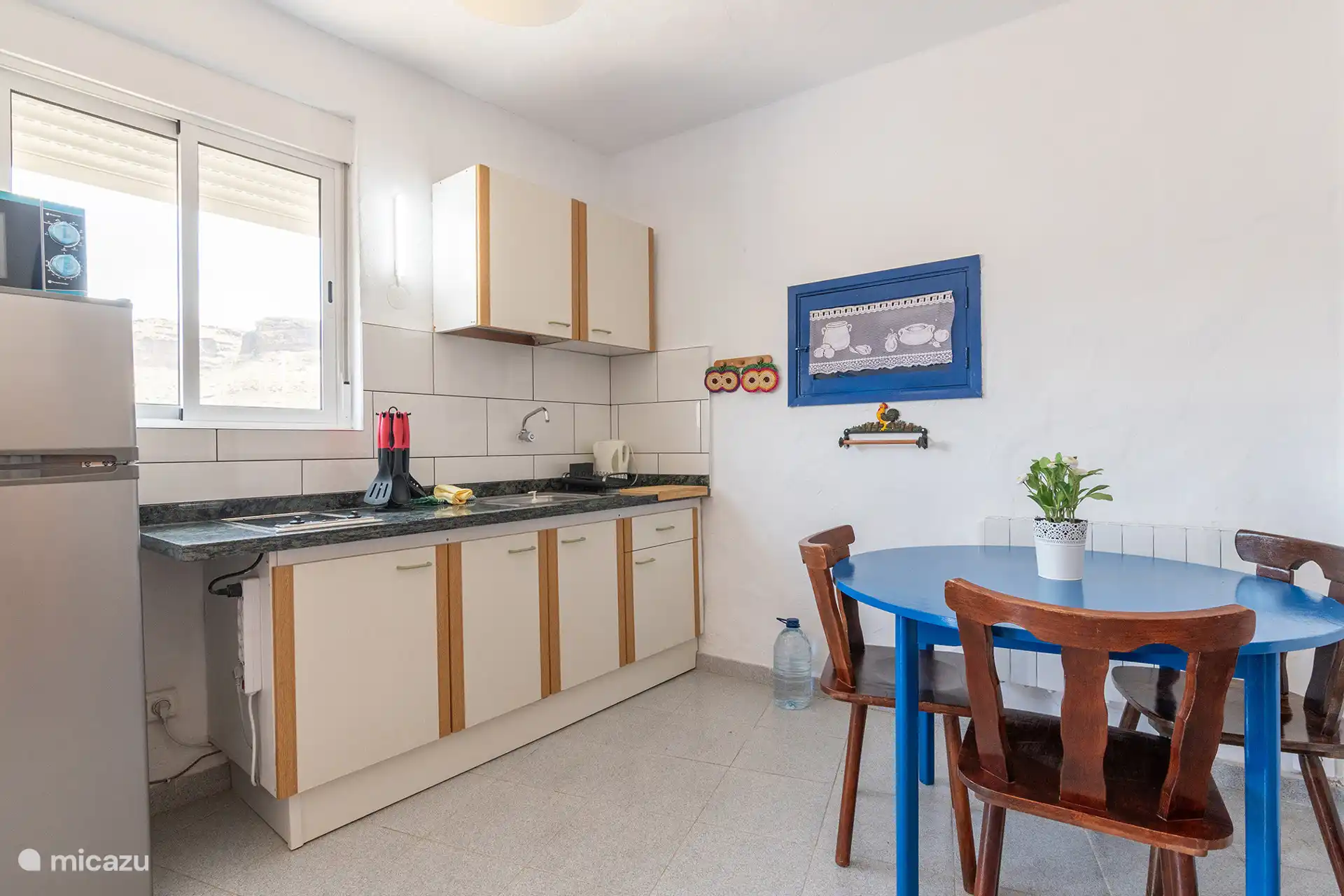 The kitchen, with a round table for dining and electric heating.