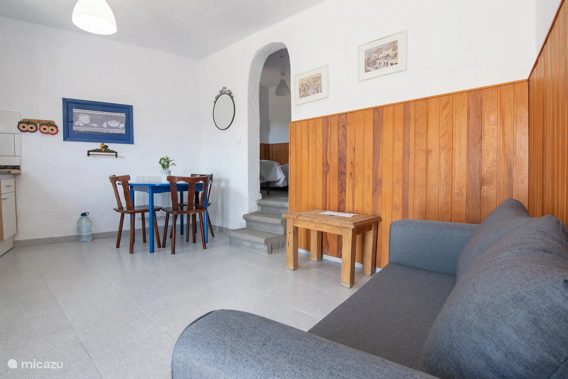 Living and dining room; in the background, the steps that go up to the bedroom.