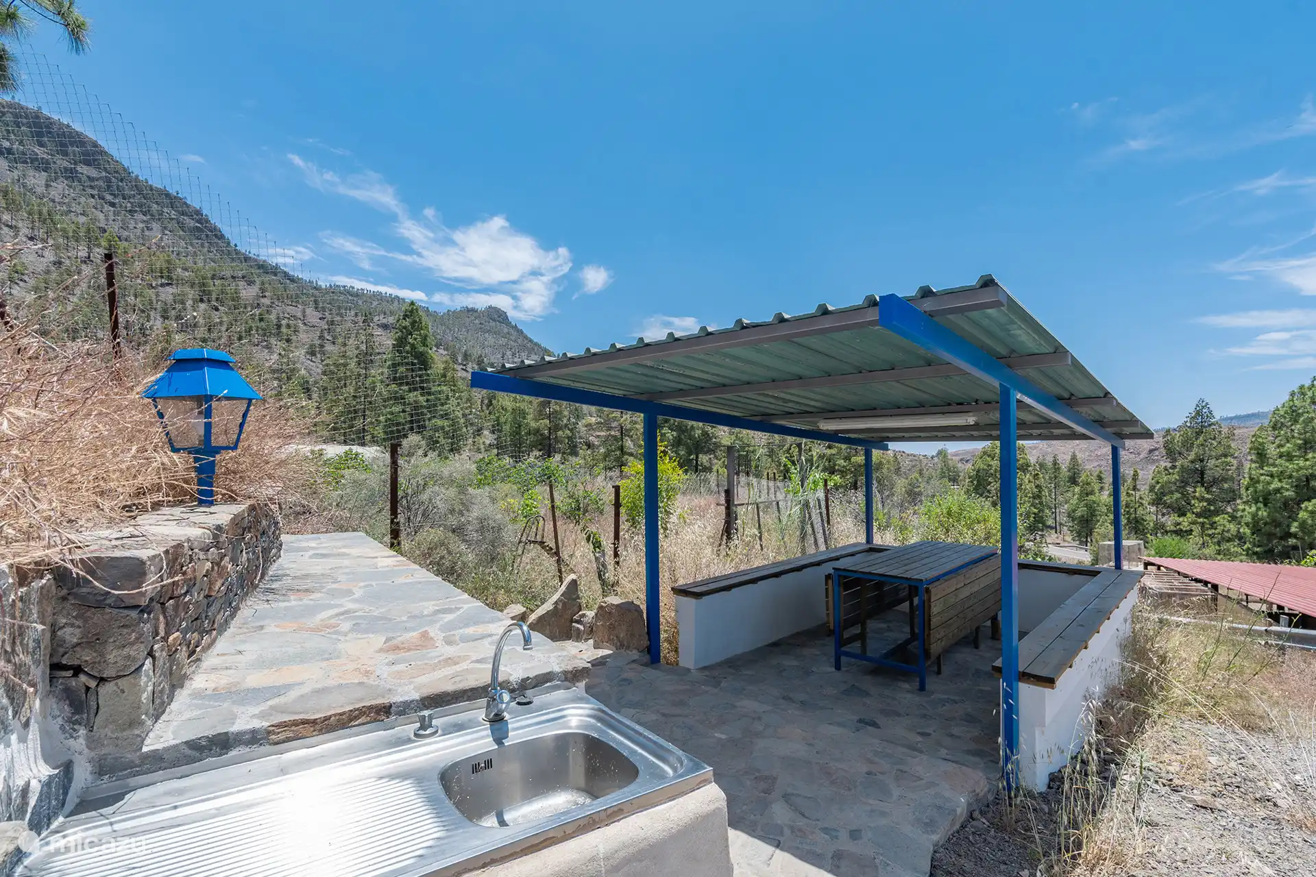 Common barbecue area, with outdoor sink and indoor tables.