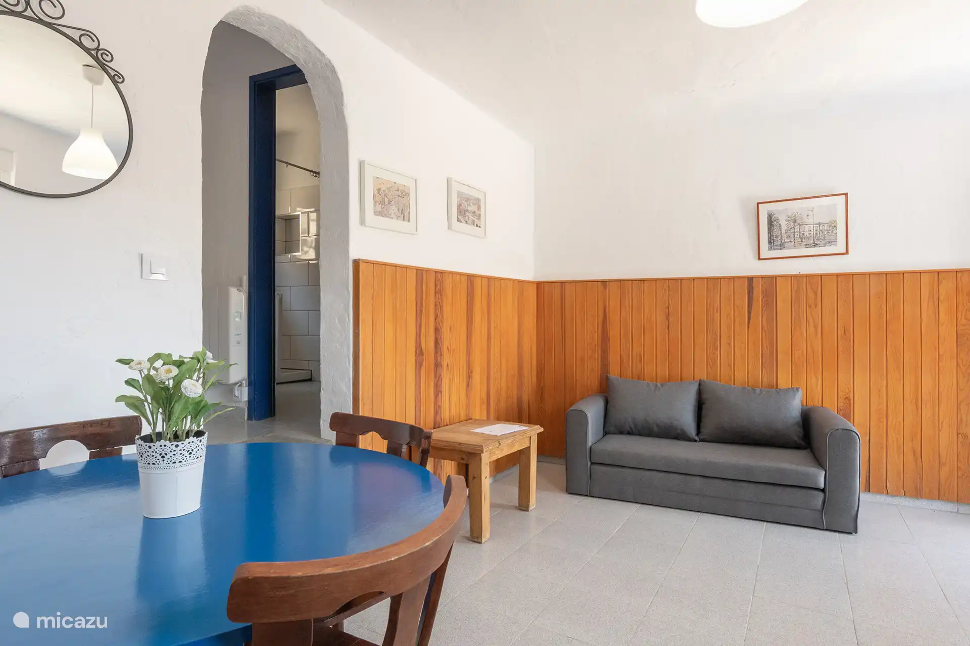 The living room, with the sofa bed and the passage to the bathroom.