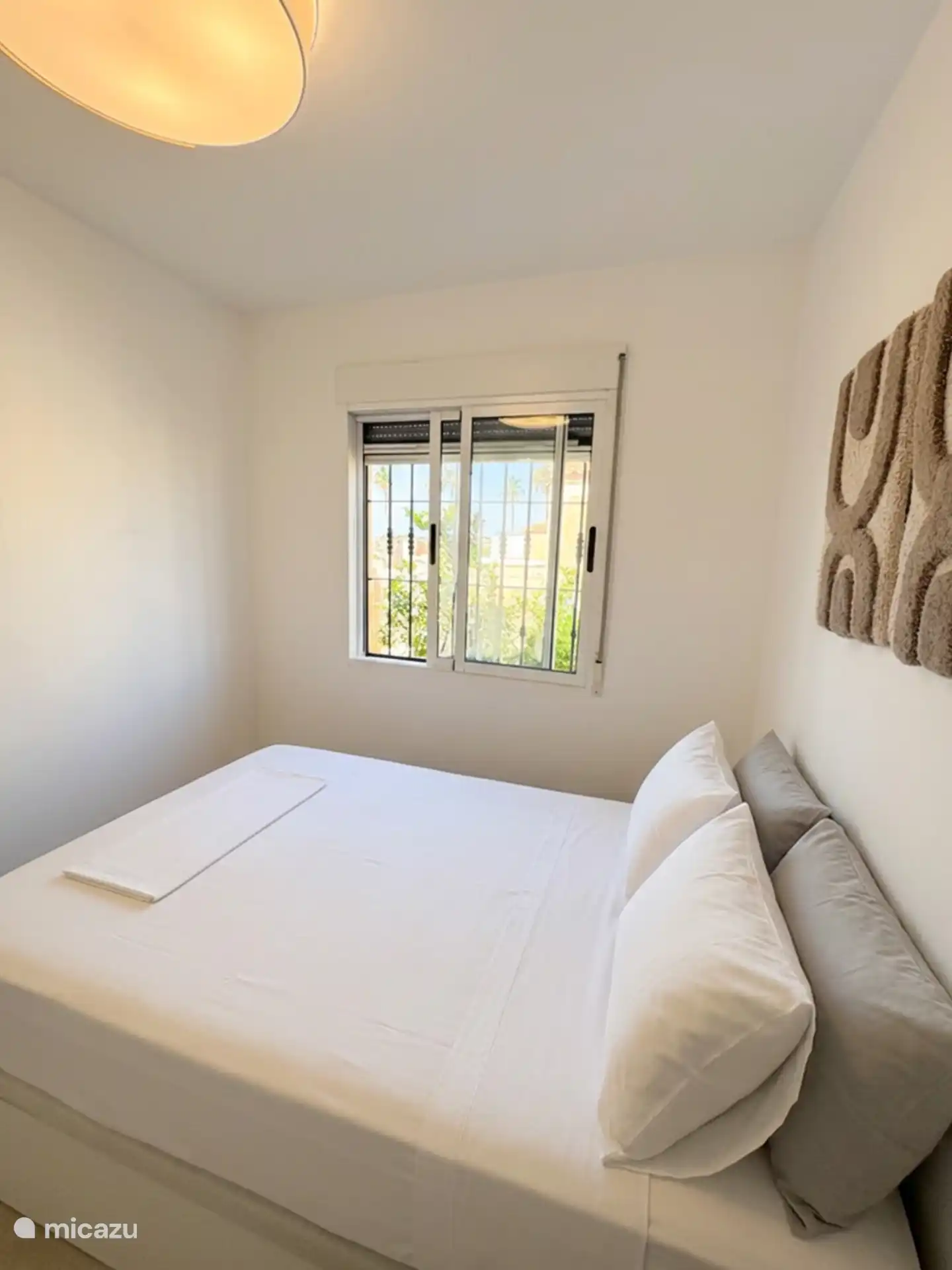De slaapkamer boven met plafondventilator, airco en ensuite badkamer.