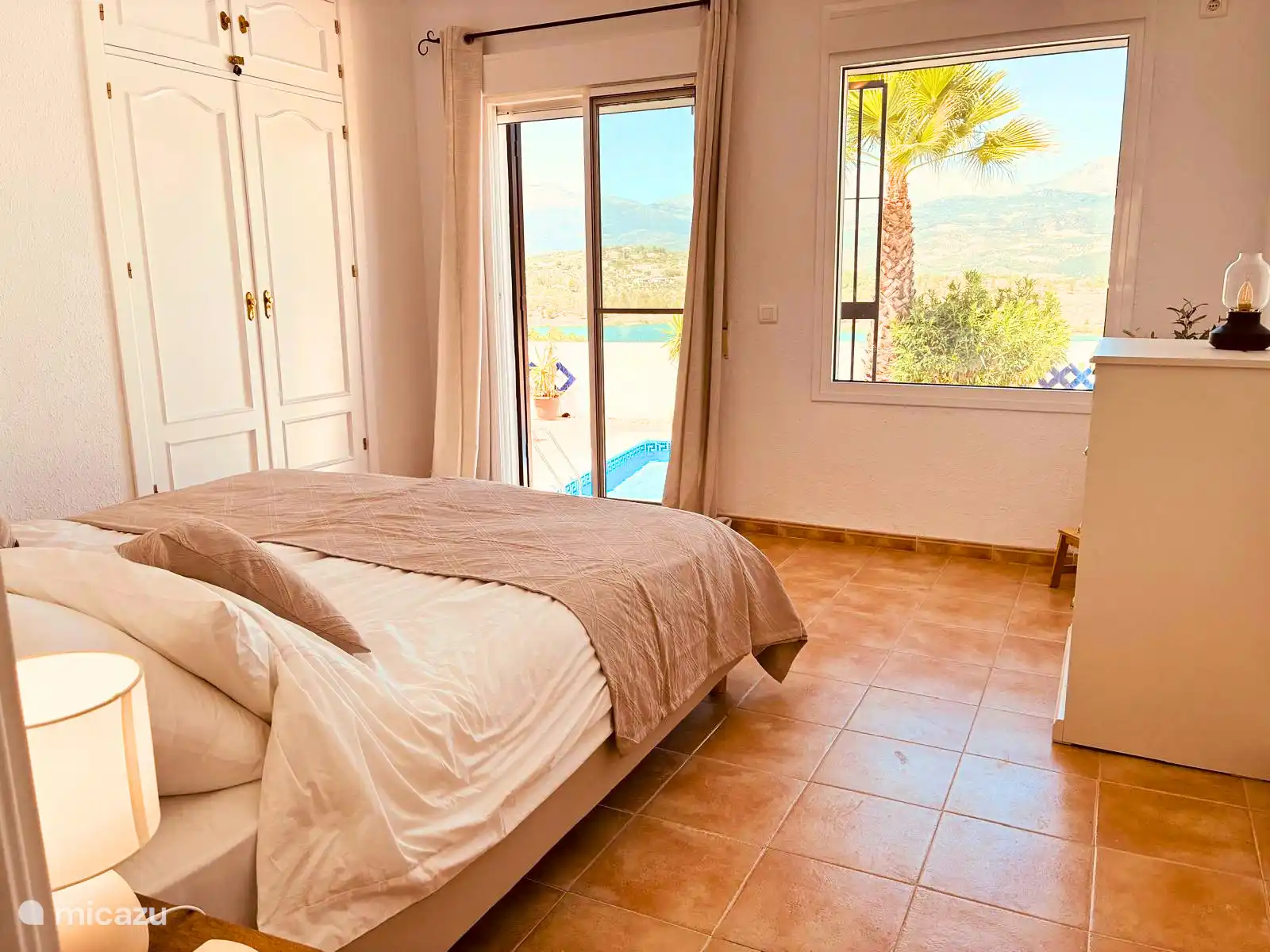 Bedroom with ensuite bathroom and direct access to lower terrace and pool