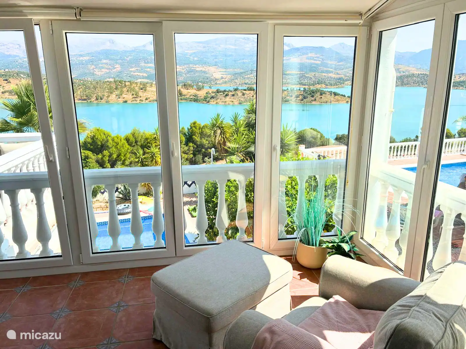 The glazed sun room with two relaxing chairs