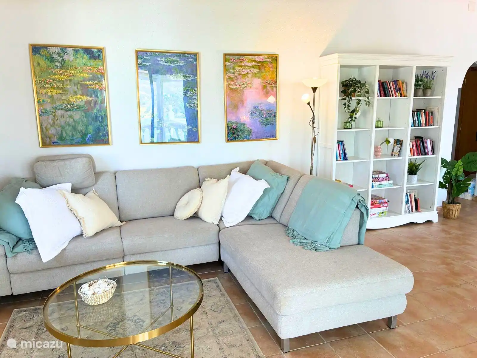 Relax on the large sofa with a book from the shelves