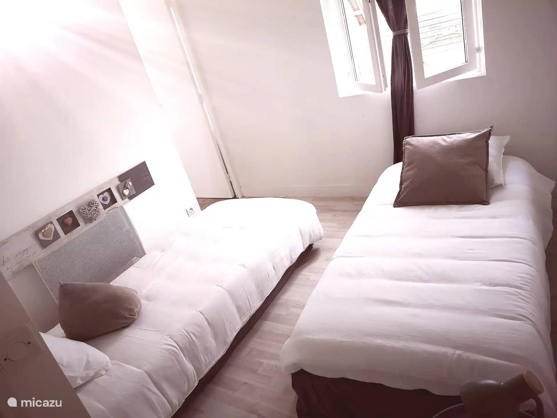 Kamer met twee eenpersoonsbedden die aan elkaar kunnen worden gekoppeld