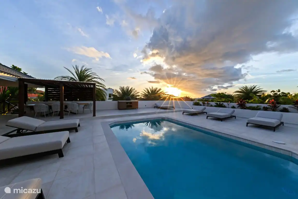 Preciosa terraza de piscina con una preciosa puesta de sol