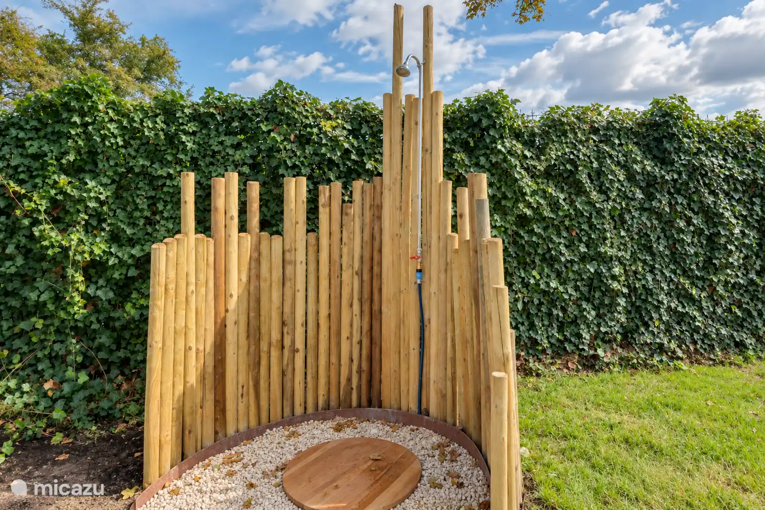 La douche extérieure abritée est merveilleuse après une journée à la plage lors d’une journée ensoleillée dans le jardin