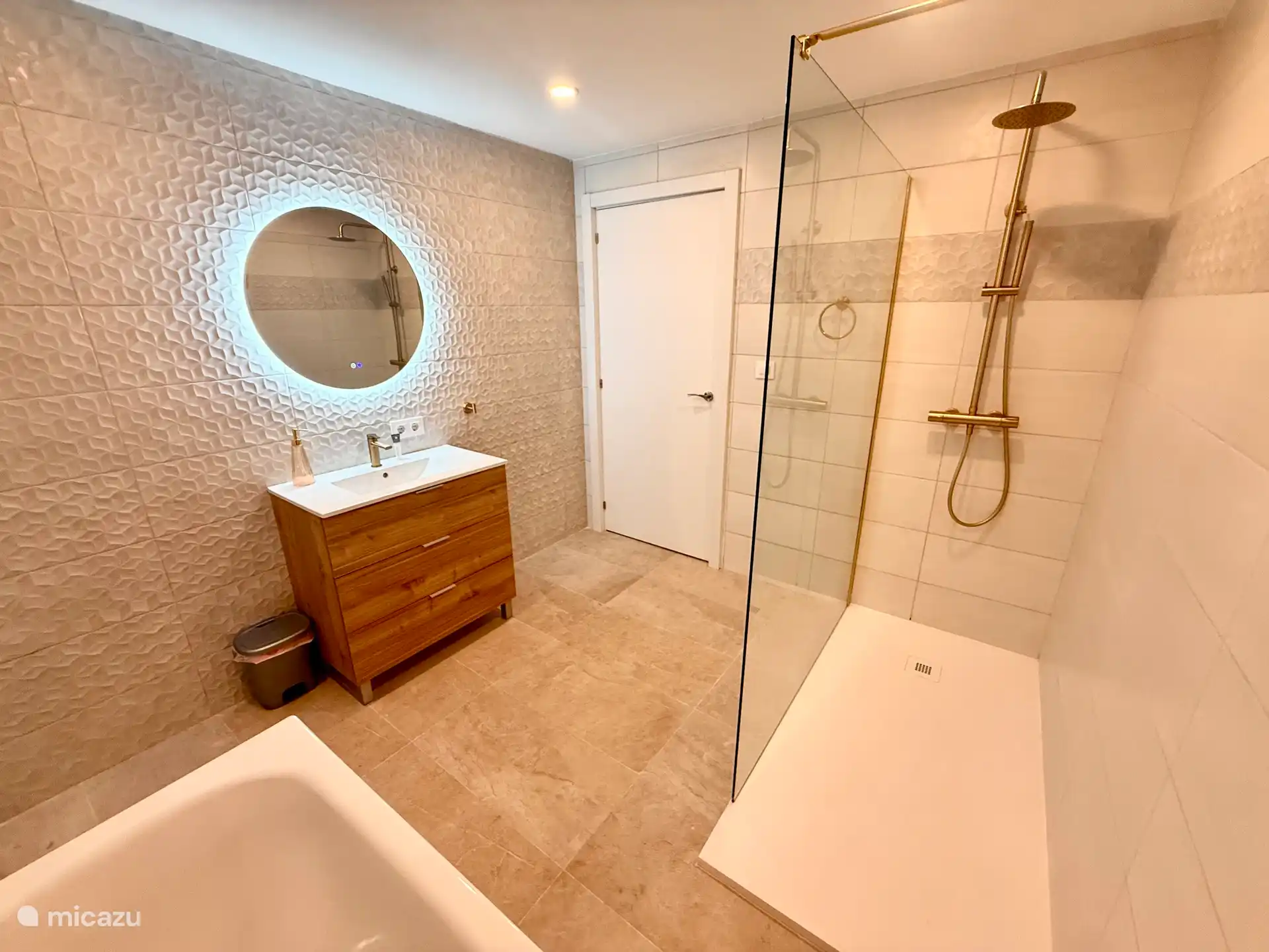 New large bathroom with large walk-in shower with waterfall shower.