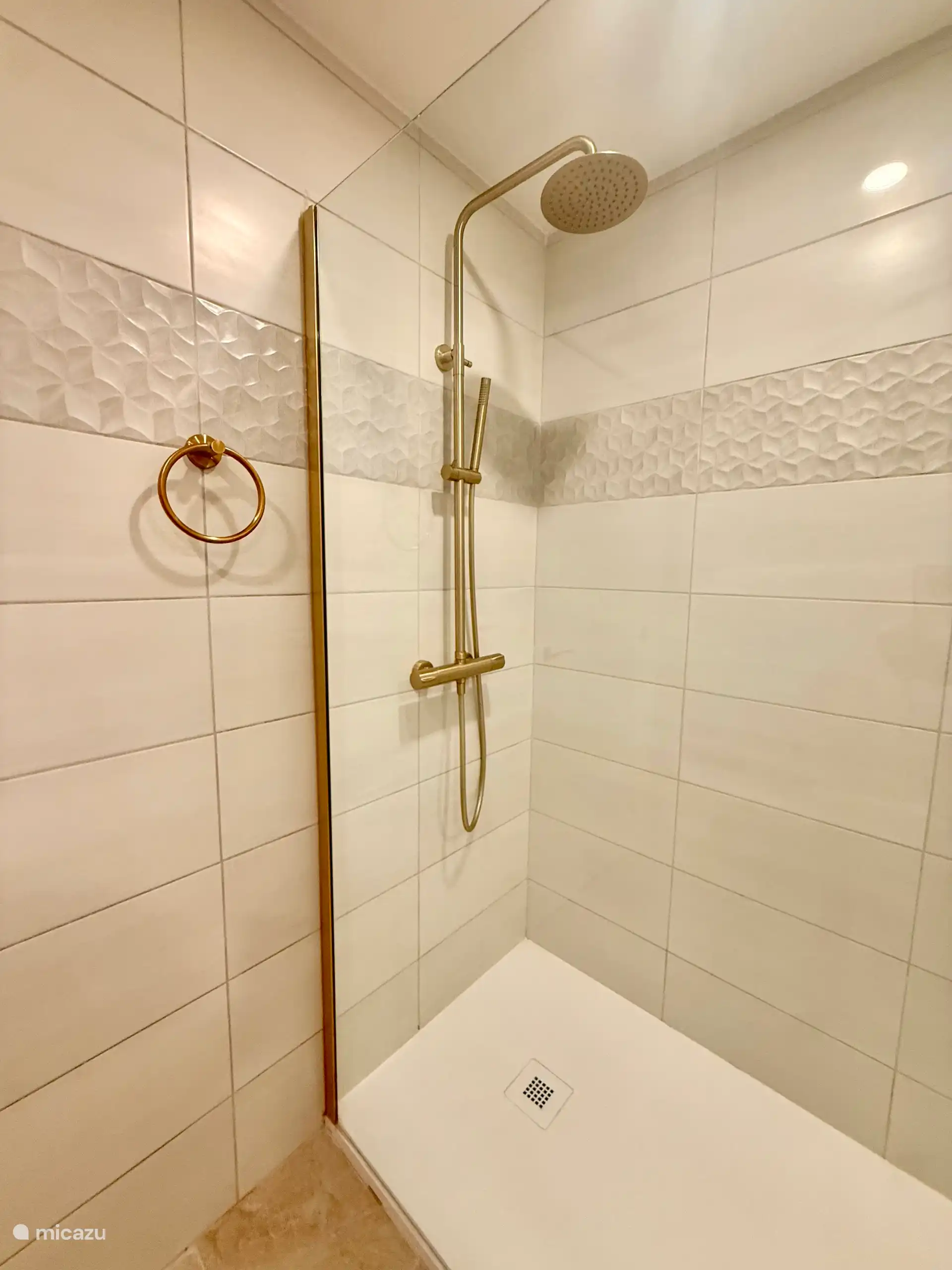 Gold-colored waterfall walk-in shower