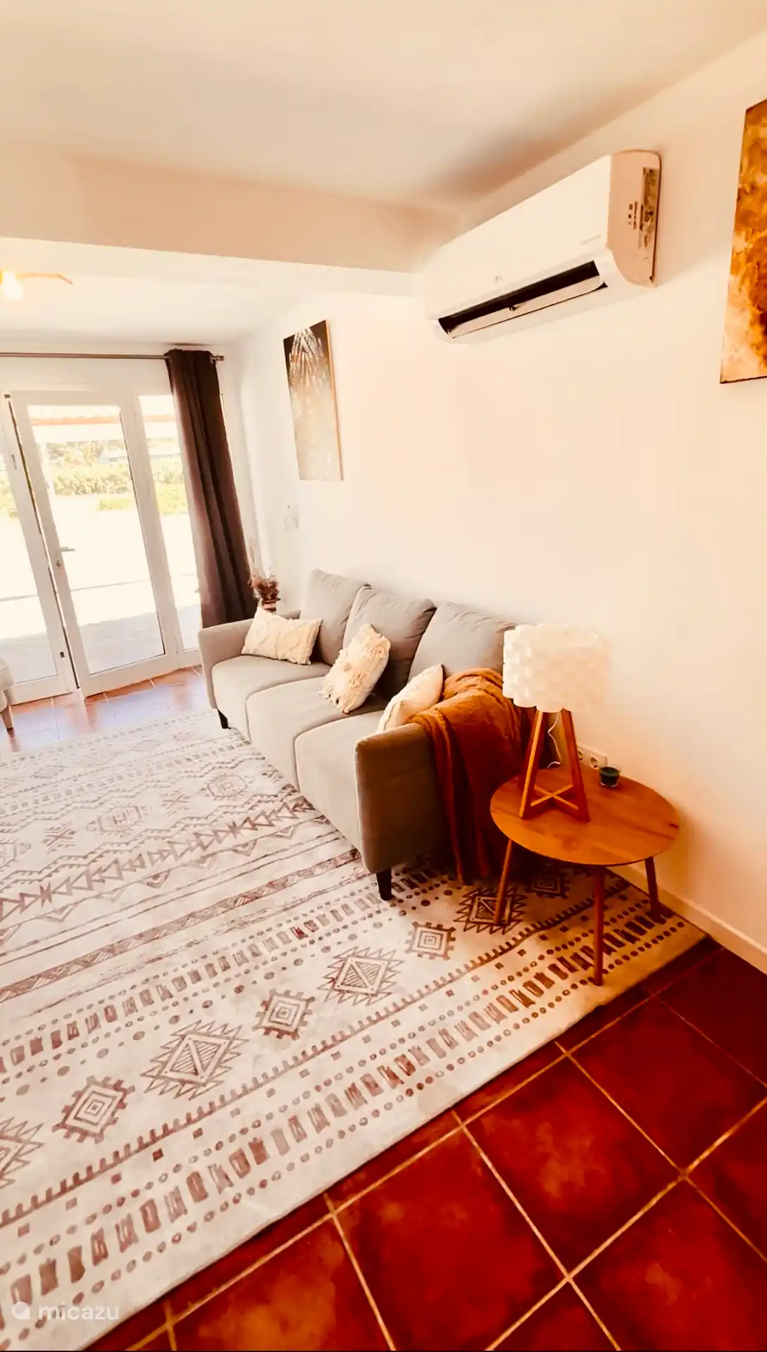 Living room with air conditioning and French doors. 