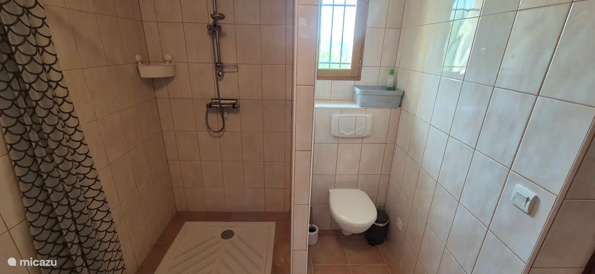 The ensuite bathroom has a spacious shower, a dressing table with plenty of shelf space for all your belongings and a toilet.