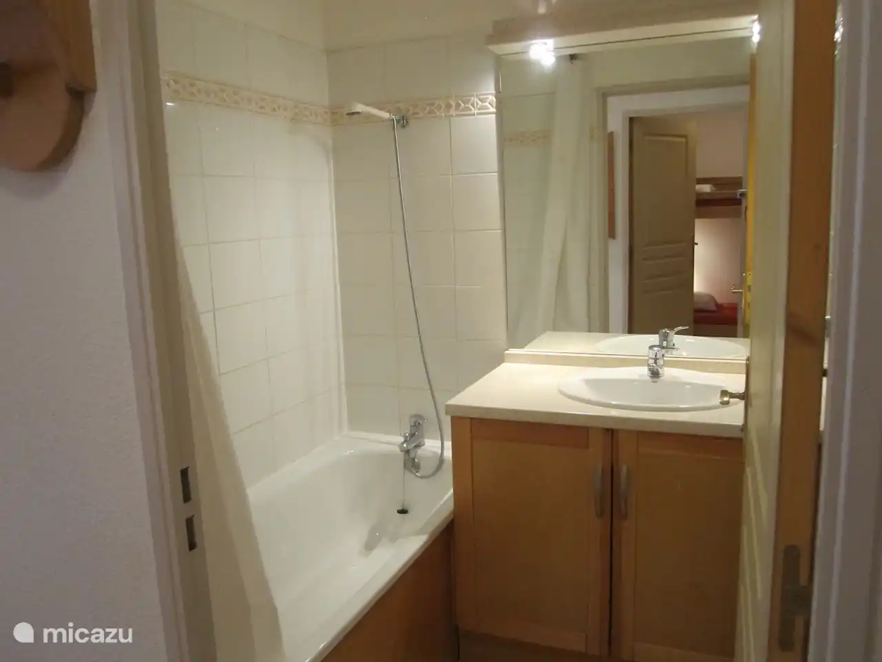 Bathroom with bath/shower, sink and storage space
