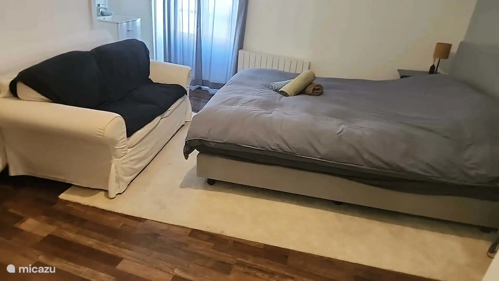Knusse tweede slaapkamer met comfortabel groot tweepersoonsbed en een eigen compacte badkamer met douche, toilet en wastafel. Een fijne, zelfstandige slaapruimte voor twee personen.