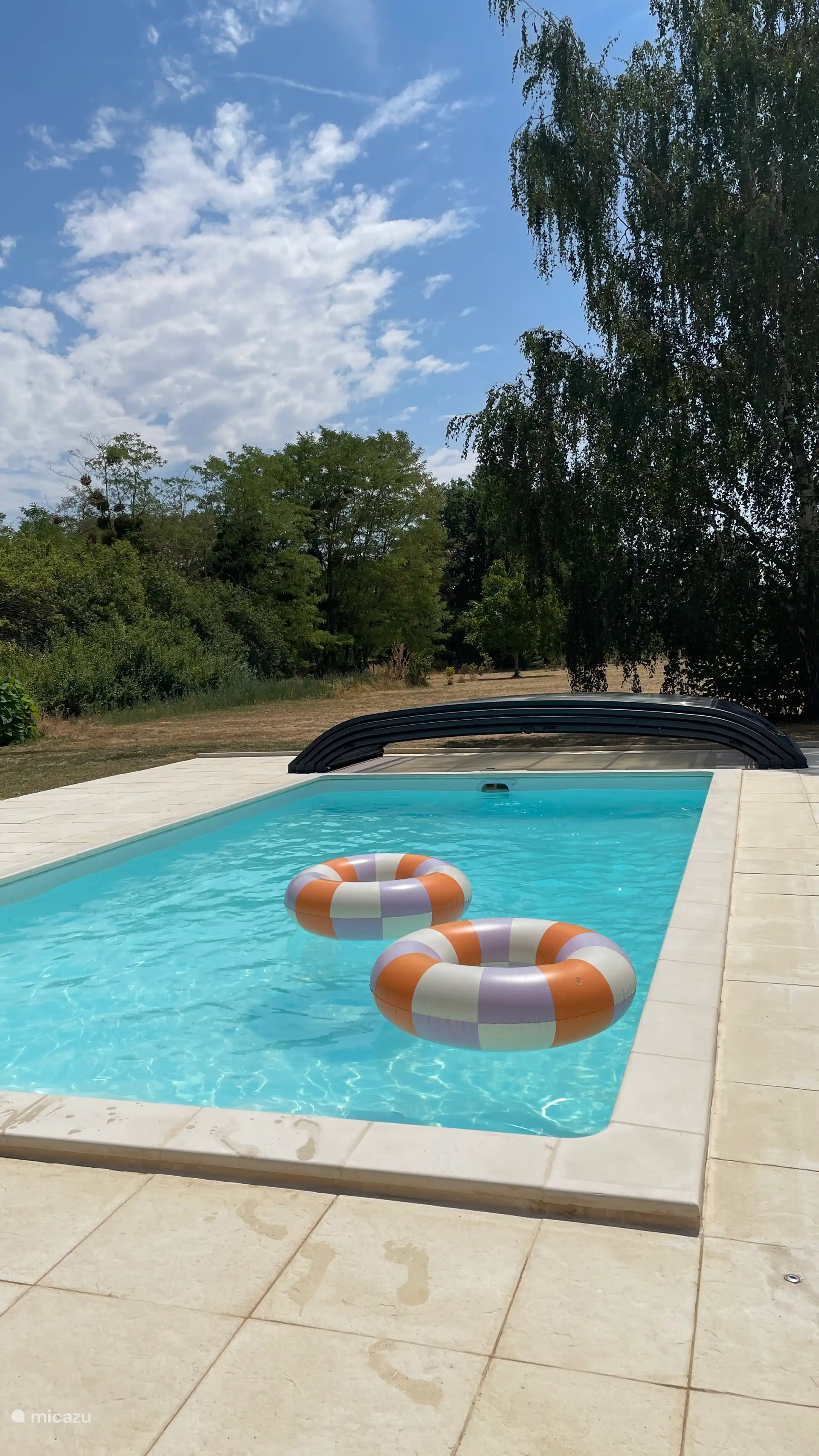 The pool with toys, the hardcover can slide all the way back on the pool deck. 