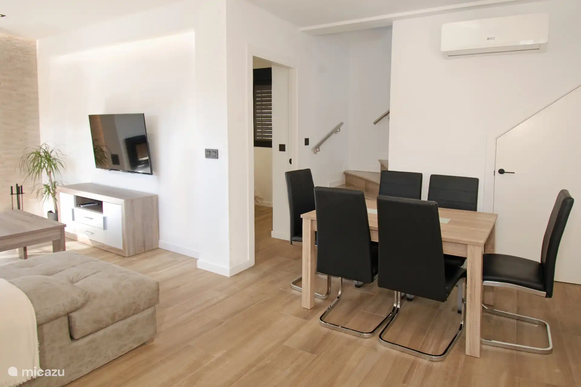 An open plan living space with dining area, lounge and kitchen. 