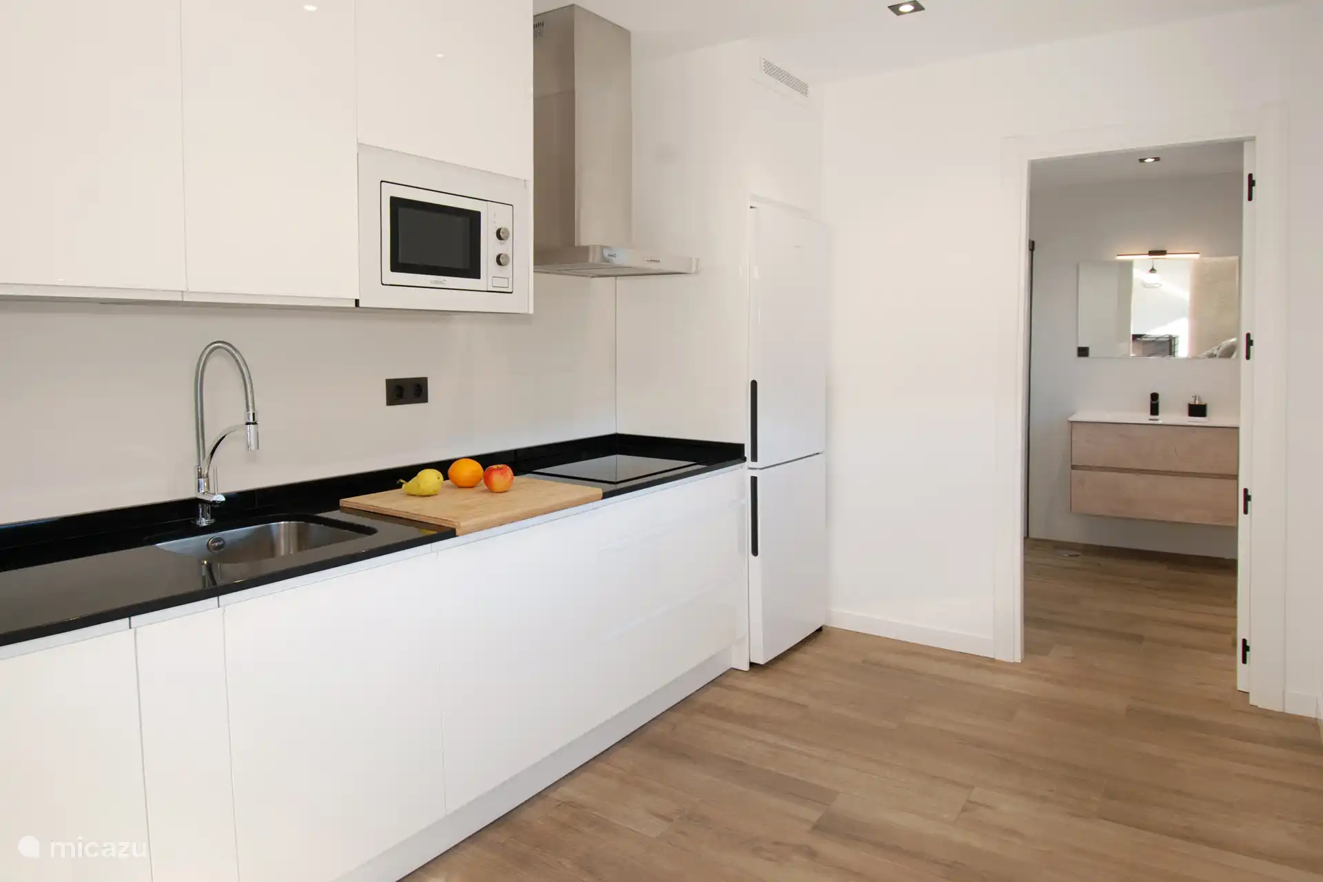 All accessories (dishwasher, oven, microwave, induction hob, combi fridge/freezer, washing machine) are provided.