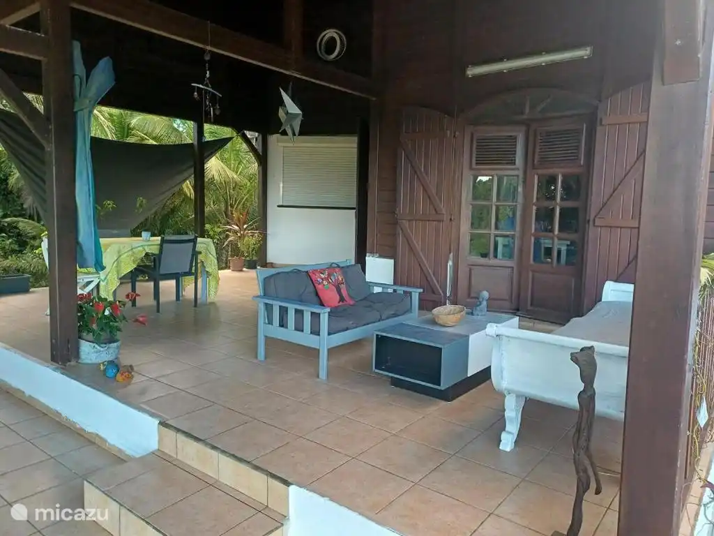 Terrasse mit Blick auf die Küche (Rollladen) und den Eingang zum Wohnzimmer