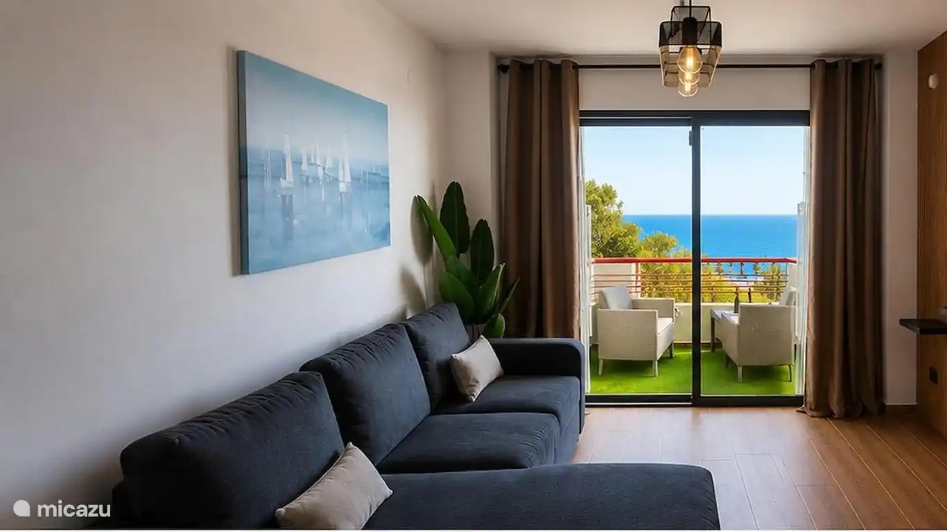 Bright living room with access to the balcony and sea views