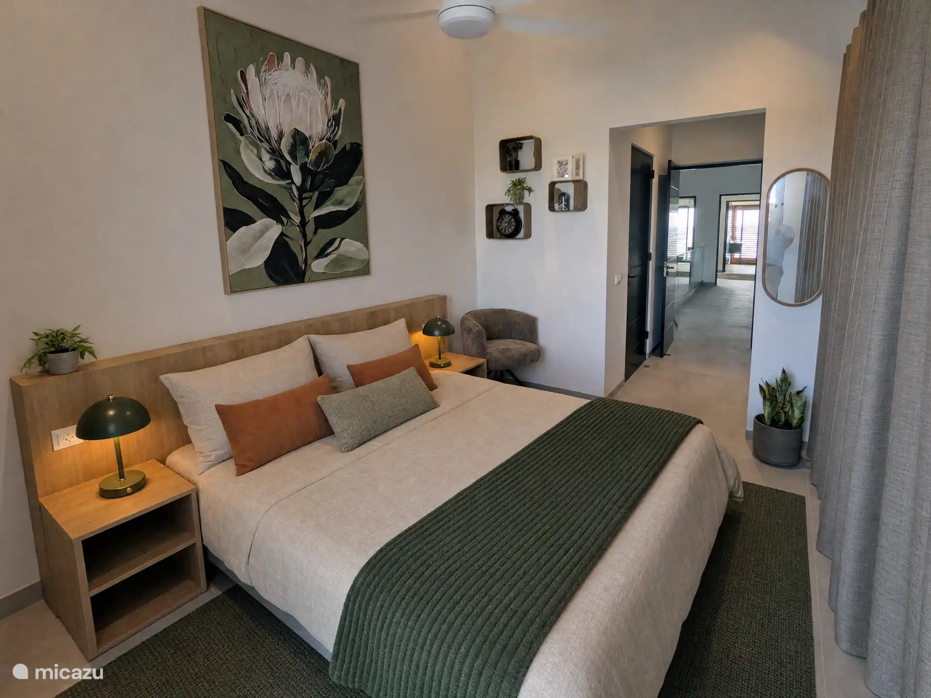 Second bedroom with king size bed, air conditioning and ceiling fan.