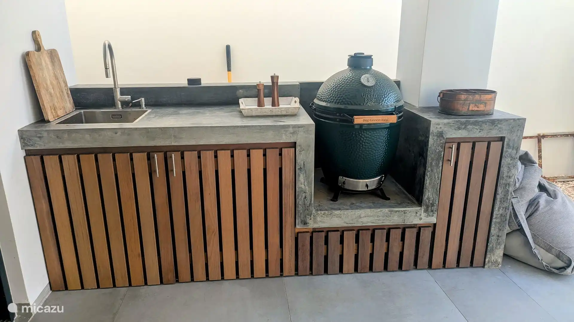 Outdoor kitchen with charcoal barbecue.