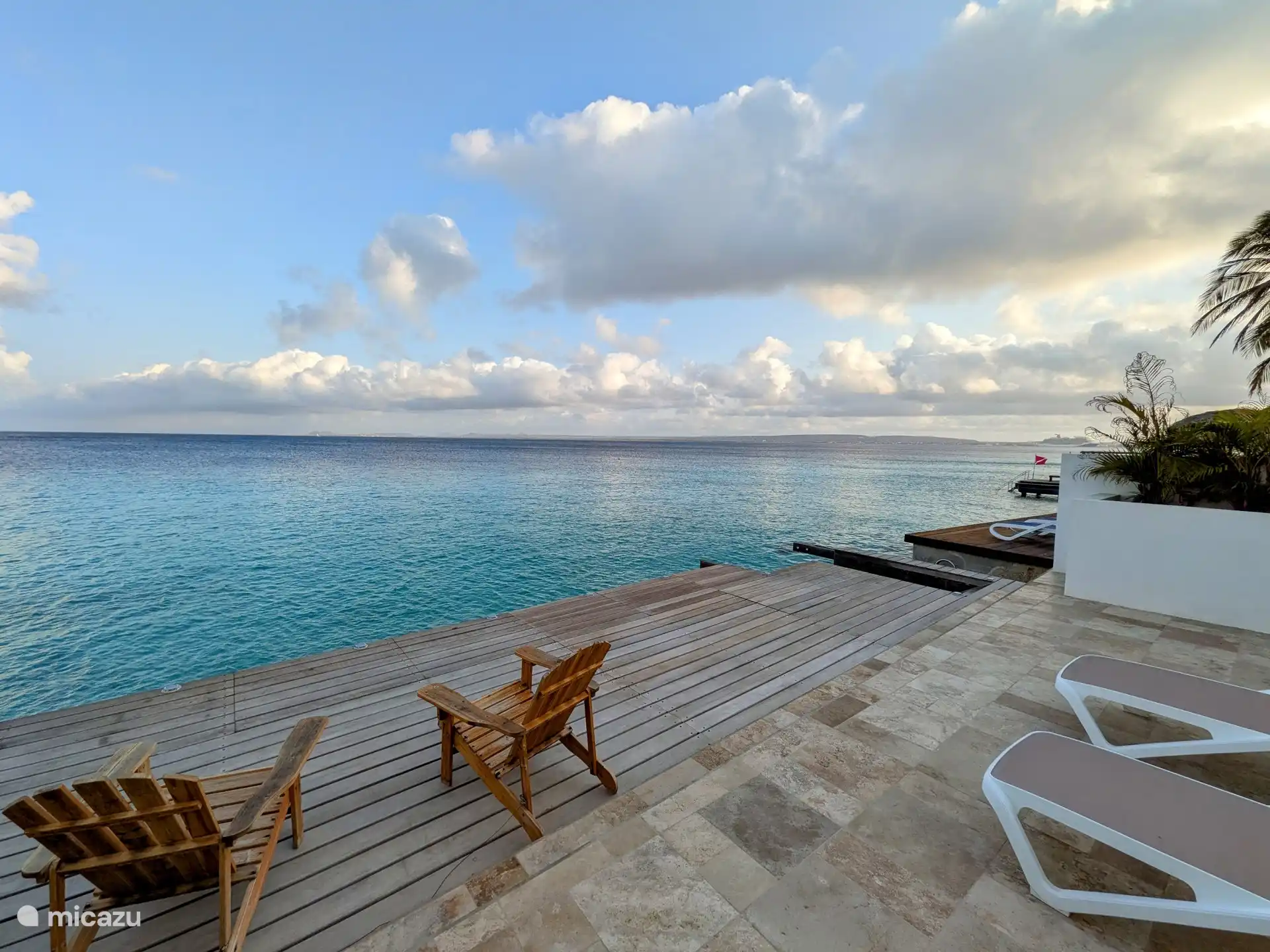 Lounge chairs on the terrace by the sea.