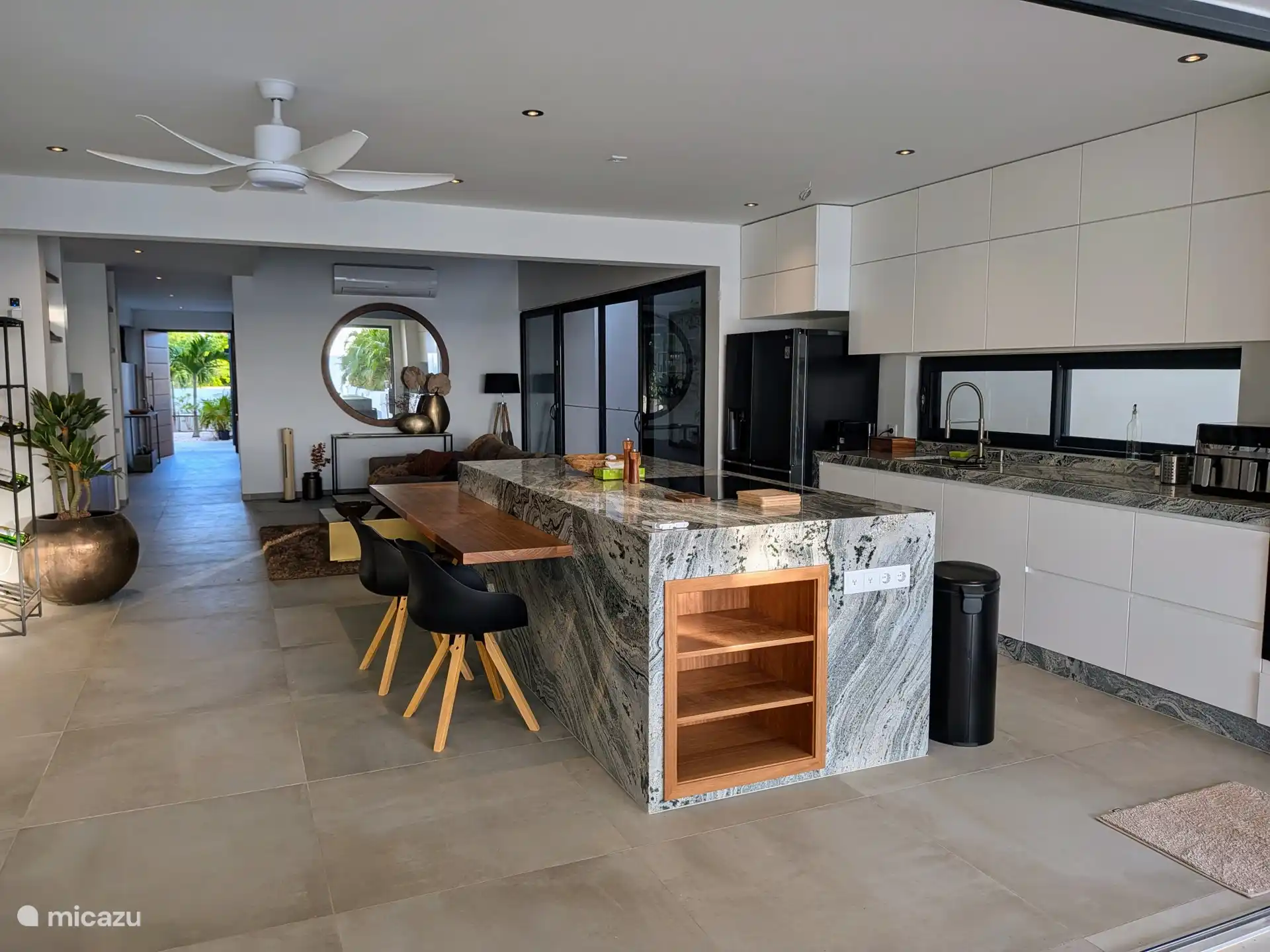 Open kitchen with cooking island and seating.