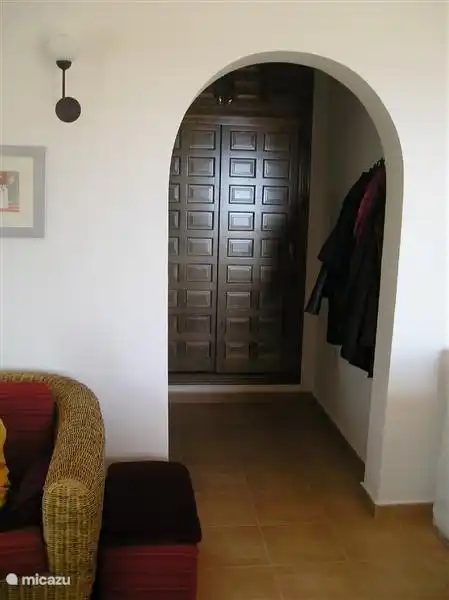The entrance hall with built in cupboard. Here is also a washing machine.
