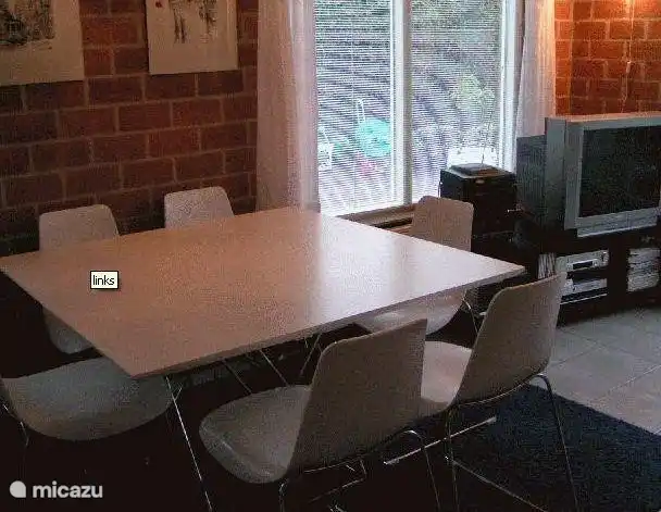 The spacious dining area adjoins the kitchen and seating for six people