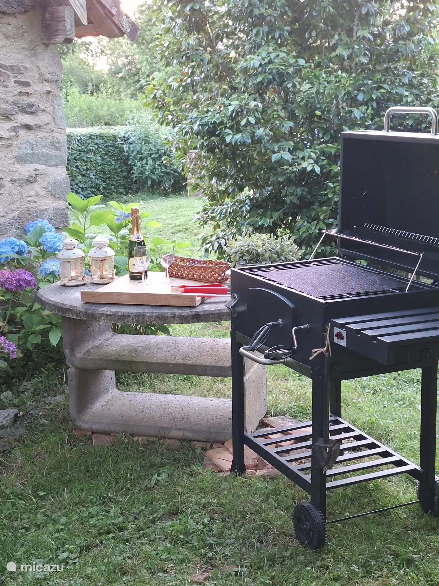 The base of the old bbq is now a table with the bbq next to it 