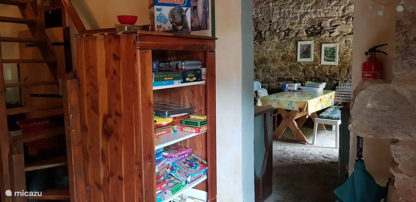 Games cabinet, through the passage you enter the guest kitchen and play area. 