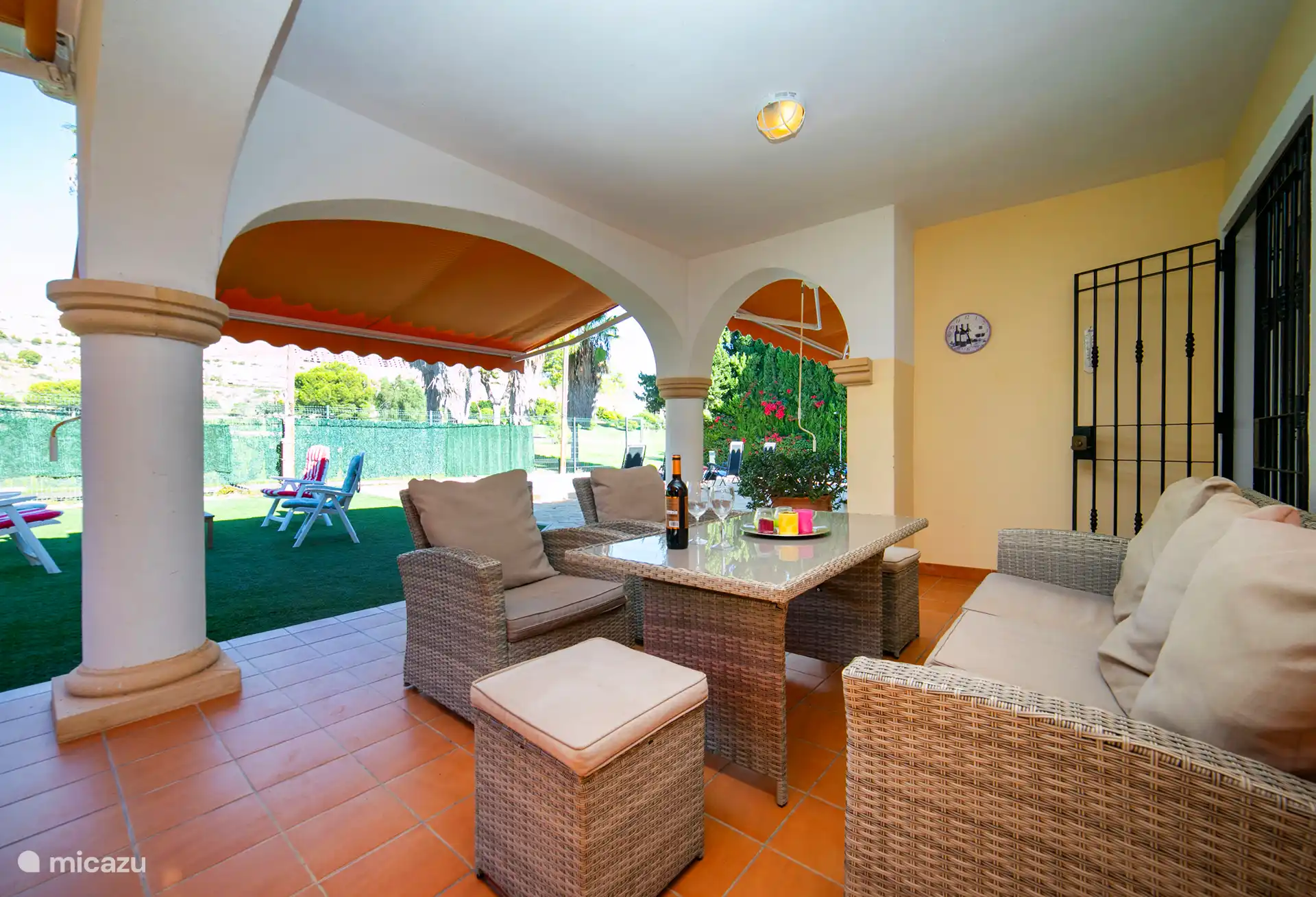 Patio couvert avec vue sur le jardin et la piscine