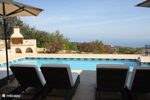 Sous la véranda, une vue magnifique sur la piscine et la terrasse