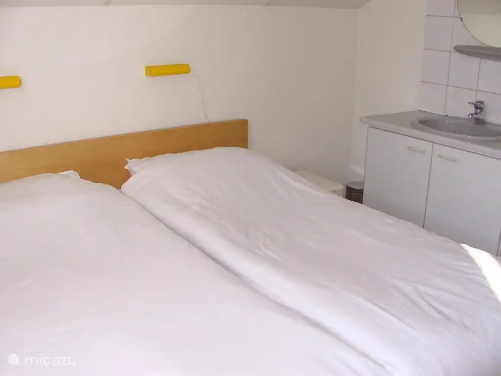 The same bedroom from a different angle screens in all rooms are placed so you can sleep with the windows open