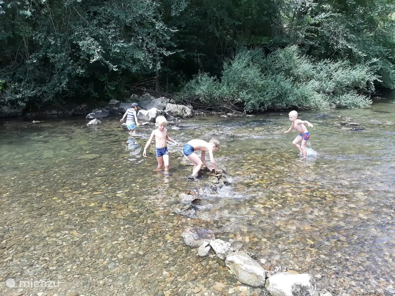 Lovely building a dam in the river at the Cave Le mas `d Azil